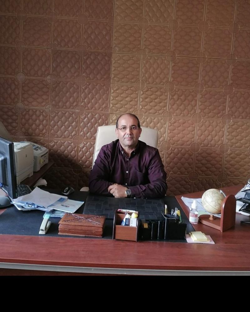 Desk in the AL-WASET office with files, globe and computer